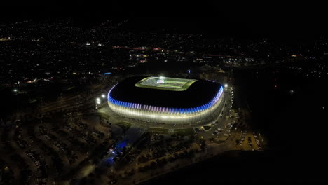 Aerial-view-around-the-Estadio-BBVA-stadium,-night-in-Monterrey,-Mexico---orbit,-drone-shot