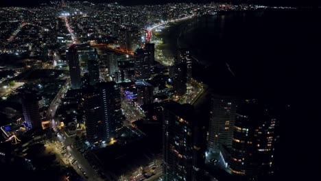 Aerial-revealing-shot-of-the-vibrant-lights-that-can-be-seen-at-night-in-Iquique