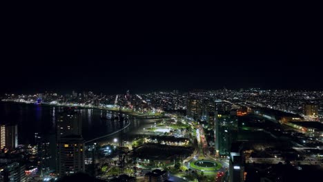 Aerial-establishing-shot-of-the-crowded-downtown-Iquique-at-night-with-bright-lights