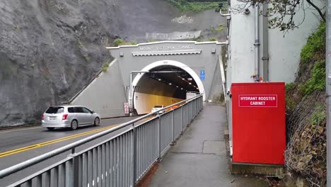 Commuter-traffic-driving-in-and-out-of-Mount-Victoria-Tunnel-from-Hatatai-suburb-in-capital-city-of-Wellington,-New-Zealand-Aotearoa