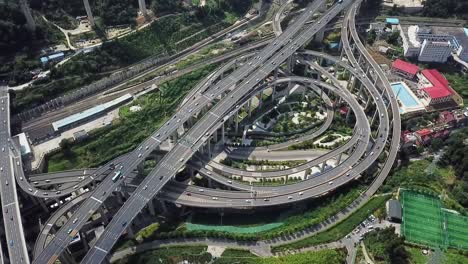 spinning-aerial-shot-of-the-highway-intersection-and-freeway-bridges-of-Chongqing,-Huangjuewan,-China,-daytime