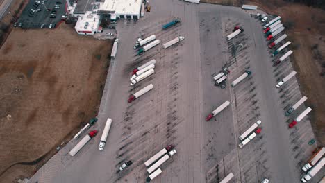 Dry-van-trailer-semi-truck-driver-exiting-truck-stop-parking-lot