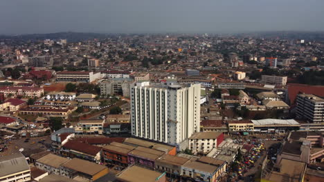 Aerial-view-towards-the-Hotel-Adamaoua,-in-sunny-Yaounde-city,-Cameroon---tilt,-drone-shot