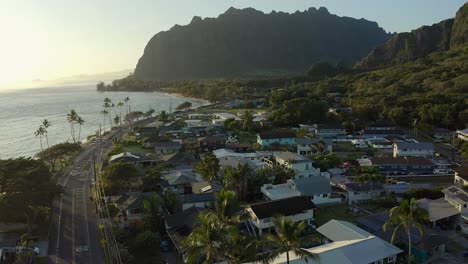 Aerial-shot-of-the-calm-village-of-Kaaawa-Hawaii-during-sunrise-going-toward-the-Kualoa-Ranch