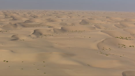 Aerial-low-establishing-helicopter-of-the-vast-Arabian-desert-dunes,-UAE