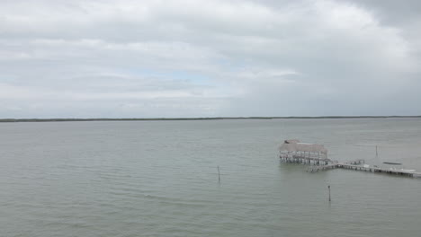 Aerial-video-on-a-cloudy-day-over-a-small-pier-in-a-lake
