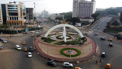 Aerial-view-away-from-the-the-Prime-Ministerial-Roundabout,-in-Yaounde,-Cameroon---pull-back,-drone-shot