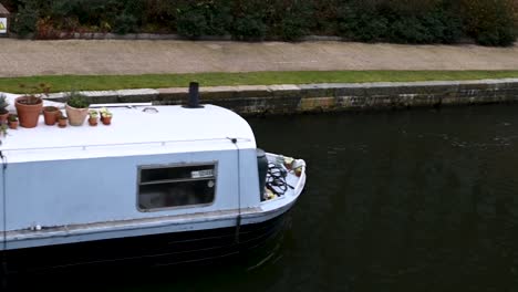 Blue-Canal-Boat-Going-Past-On-The-Regents-Canal,-London,-United-Kingdom