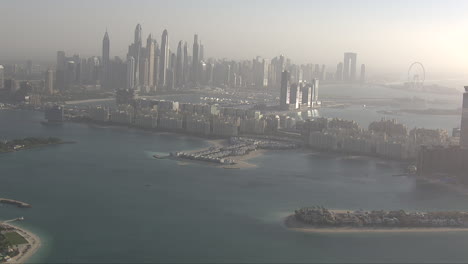Aerial-establishing-shot-of-downtown-Dubai-with-parts-of-Atlantis-coming-into-frame