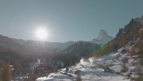 Breathtaking-backwards-panning-aerial-of-iconic-Matterhorn,-Zermatt,-Valais,-Switzerland