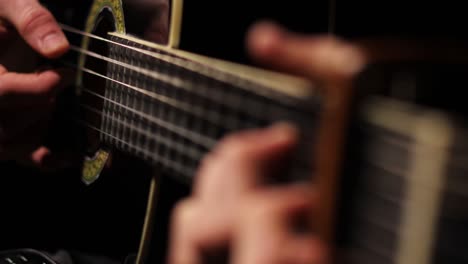Beautiful-moving-focus-shot-of-the-hands-of-a-man-playing-the-guitar
