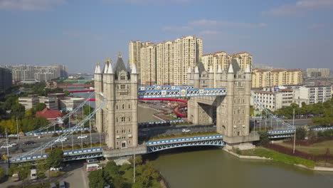 Aerial-circles-massive-Tower-Bridge-replica-on-canal-in-Suzhou,-China