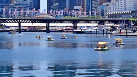 Editorial-illustrative-view-of-the-rental-pedal-boats-at-Darling-Harbour-in-Cockle-Bay,-Sydney,-near-the-National-Maritime-Museum