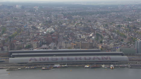 Aerial-establishing-shot-of-the-Central-train-station-in-downtown-Amsterdam