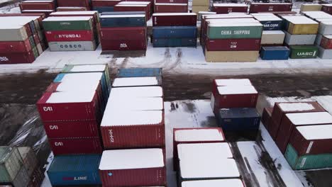 Shipping-containers-covered-with-snow-in-Detroit-harbor,-aerial-ascend-view