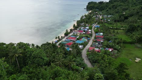 Aerial,-Establishing,-shot-of-small-tropical-island-village-and-beach-with-bangka-boats