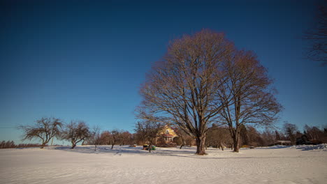 Remote-farmstead-on-bright-winter-day,-fusion-time-lapse