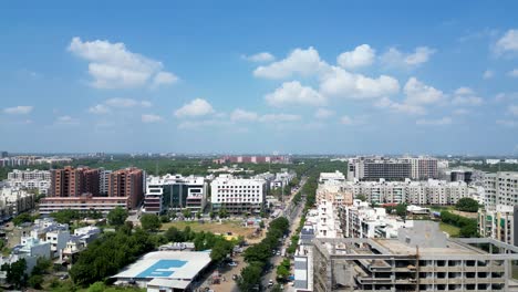 High-rise-building-in-India,-apartment,-flats,-business,-office-space,-Drone-shot-with-blue-sky,-Gandhinagar,-Gujarat,-India