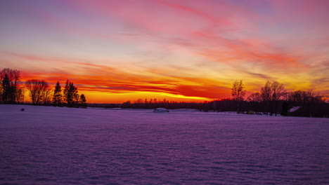 Vibrant-colorful-sky-of-early-morning-sunrise-in-winter-rural-landscape,-fusion-time-lapse