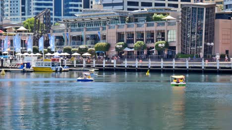Editorial-illustrative-view-of-the-rental-pedal-boats-at-Darling-Harbour-in-Cockle-Bay,-Sydney,-near-the-National-Maritime-Museum