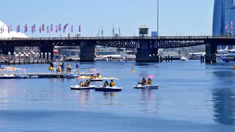 Editorial-illustrative-view-of-the-rental-pedal-boats-at-Darling-Harbour-in-Cockle-Bay,-Sydney,-near-the-National-Maritime-Museum