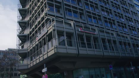 Corporate-Building-Upwards-to-Low-Panning-Shot-Schlossplatz-In-Downtown-Stuttgart-in-4K,-Red-Komodo-Cooke-Mini-S4i-Lens-Premium-Quality-|-News