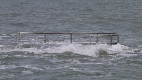Railings-and-steps-engulfed-by-a-spring-tide
