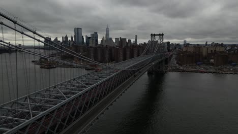A-high-angle-aerial-view-of-Lower-Manhattan-from-over-the-Williamsburg-Bridge-in-NY-on-a-cloudy-day