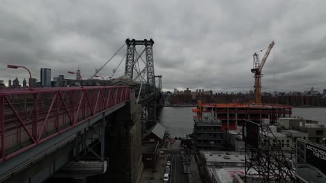 An-aerial-view-along-the-north-side-of-the-Williamsburg-Bridge-in-New-York-on-a-cloudy-day