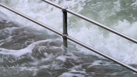 Railings-and-steps-getting-covered-by-a-high-tide