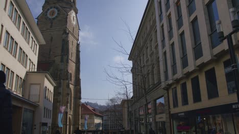 Static-Shot-of-Man-Walking-Towards-Evangelische-Schlosskirche-Schlossplatz-In-Downtown-Stuttgart-in-4K,-Red-Komodo-Cooke-Mini-S4i-Lens-Premium-Quality-|-News