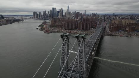 A-high-angle-aerial-view-over-the-Williamsburg-Bridge-in-NY-on-a-cloudy-day