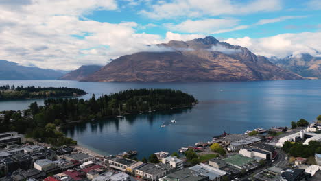 Aerial-drone-epic-view-of-Queenstown-in-shores-of-Wakatipu-lake-and-mountains-in-background