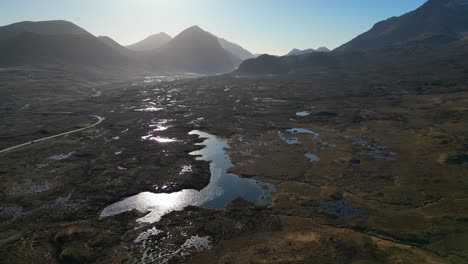 Pan-across-Scottish-wilderness-at-dawn-with-misty-Cuillin-mountains-and-Loch-Caol-at-Sligachan-Isle-of-Skye