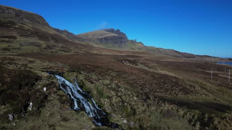 Slow-motion-high-approach-to-waterfall-in-Scottish-Highland-wilderness-at-Brides-Veil-Falls-Trotternish-Isle-of-Skye