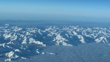Exploring-majestic-snowy-mountains-on-a-clear-winter-day-from-above