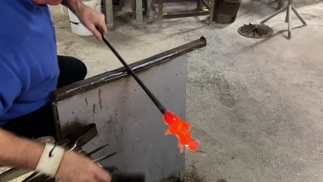 Artist-shaping-glass-into-form-with-tool-at-Murano-Glass-Factory