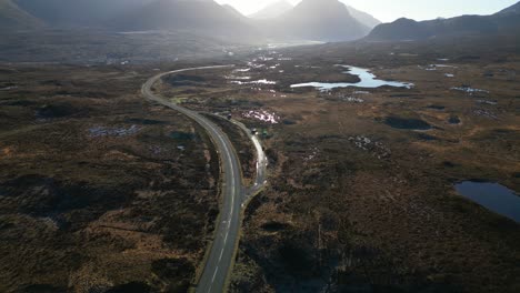 Flying-over-Scottish-Highland-road-at-dawn-towards-wilderness-and-misty-mountains-at-Sligachan-Isle-of-Skye