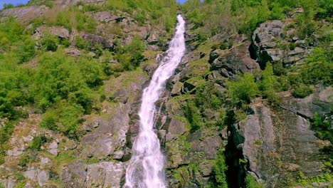Wasser-Fällt-über-Einen-Hohen-Wasserfall,-Versteckt-Zwischen-Der-Grünen-Natur