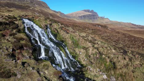 Slow-motion-approach-to-waterfall-with-The-Storr-on-the-horizon-at-Brides-Veil-Falls-Trotternish-Isle-of-Skye
