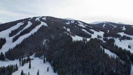 Bright-drone-aerial-views-of-ski-mountain-in-the-winter-with-trees