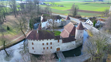 Aerial-Ascent-of-Hallwyl-Castle,-Hallwyl,-Switzerland