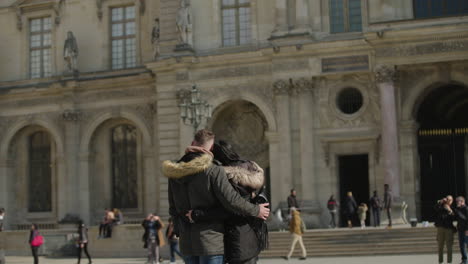 Loving-couple-lies-in-each-other's-arms-in-front-of-the-louvre