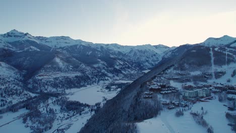Drone-aerial-view-revealing-Telluride,-Colorado-downtown-during-sunrise