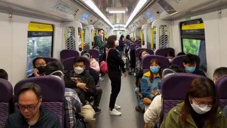 Hong-Kong-MTR-passengers-sitting-in-first-class-on-East-Rail-line-wearing-masks
