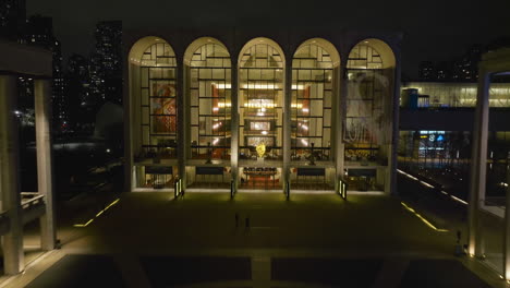 Aerial-view-rising-over-the-Lincoln-Center,-during-nighttime-in-New-York,-USA