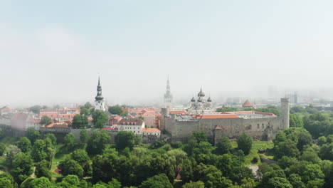 Magnificent-aerial-view-of-Old-Town-in-the-fog-in-Tallinn,-Estonia