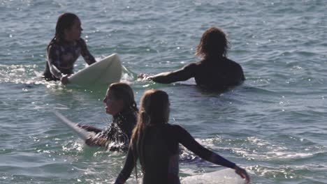 Girls-surfing-the-waves-on-a-sunny-day