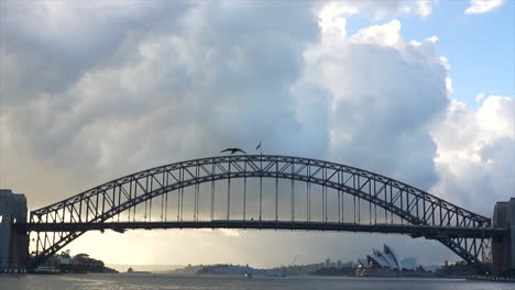 A-train-passes-across-Sydney-Harbour-bridge-on-a-white-cloudy-morning-in-Australia