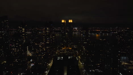 Aerial-view-rising-towards-the-illuminated-the-Rushmore-condo,-in-Upper-West-Side,-NY